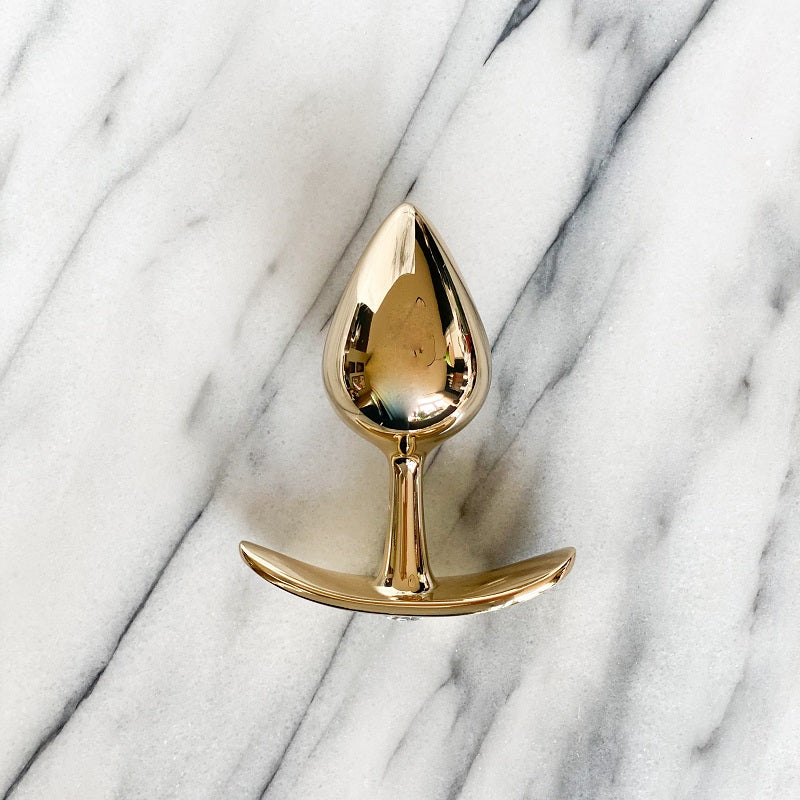 Paarse anaal plug van De Paarse Keizerin in maat S, vooraanzicht op neutrale achtergrond